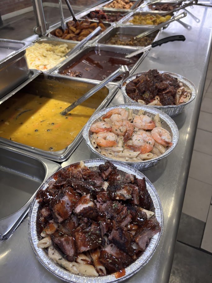 Plates of jerk chicken and sides on display.