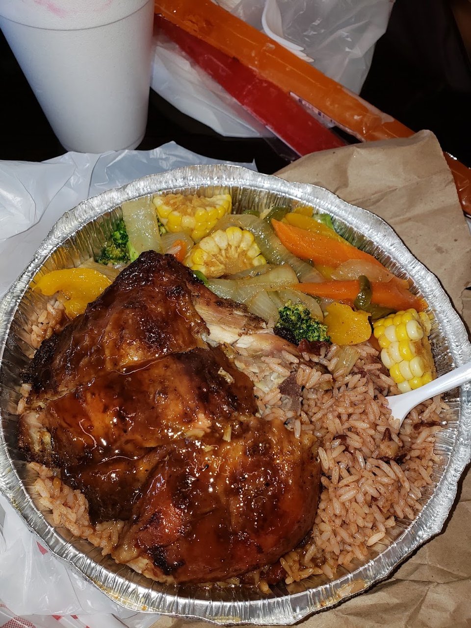 Printed menu with jerk chicken and curry goat.