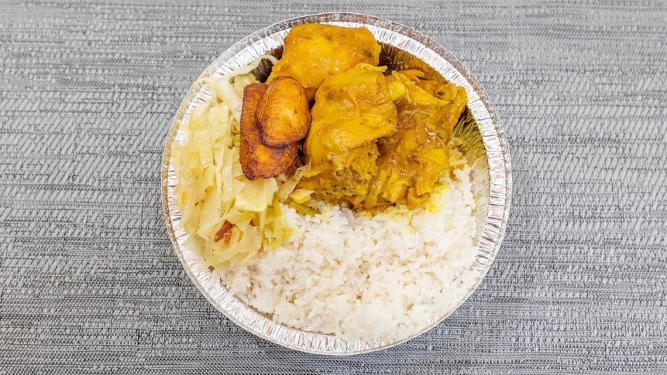 Printed menu with jerk chicken and curry goat.